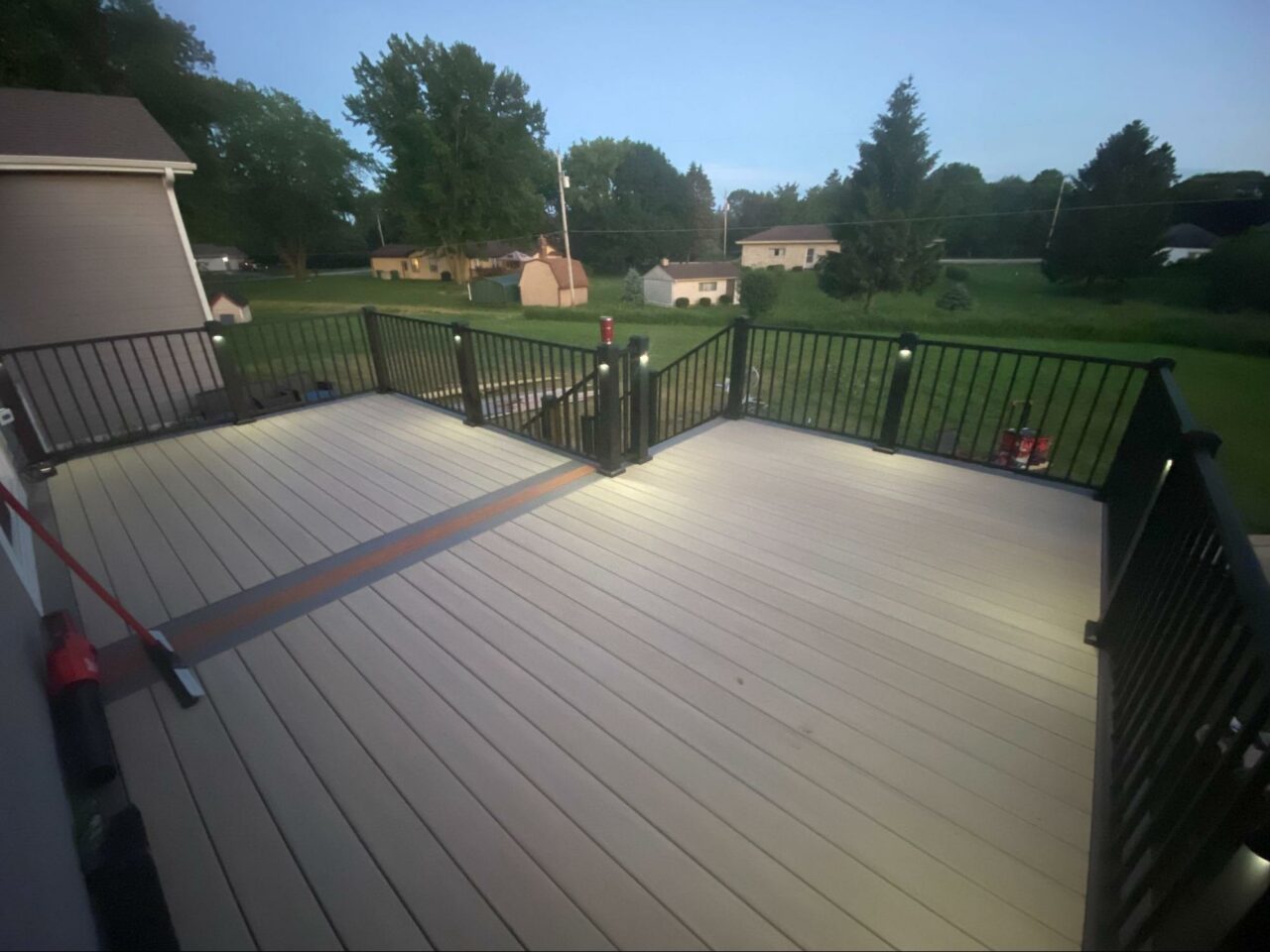 Photo of Composite Deck with Inlays, Black Railing, and Steps - Custom Deck Railings builder and contractor Services Washington County, WI