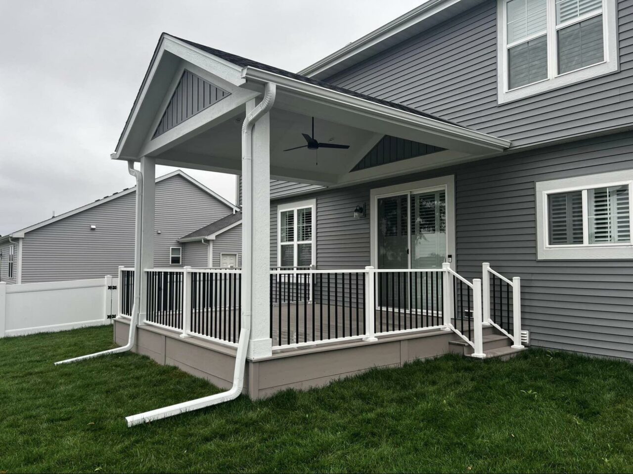 Photo of Covered Porch with Black and White Deck Railing