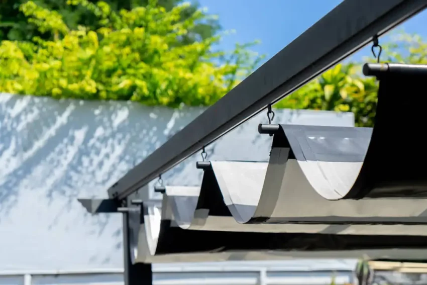 Photo of a portion of a retractable awning that provides cover for a deck.