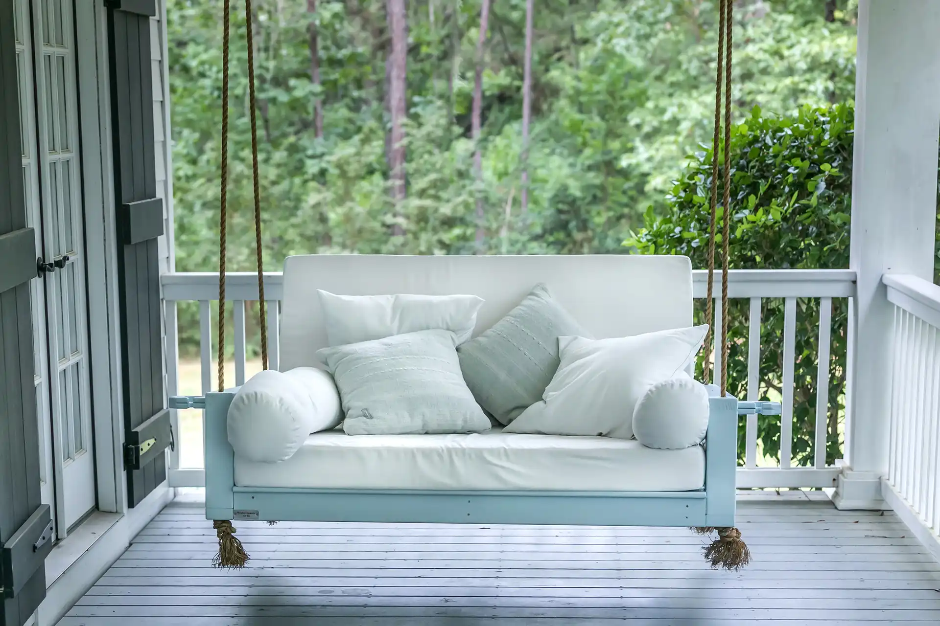 photo of a classic porch swing, which is one of several porch design ideas to elevate porches