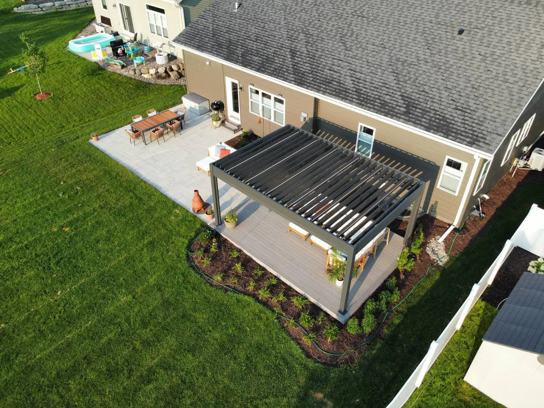 attached ground level deck with louvered pergola