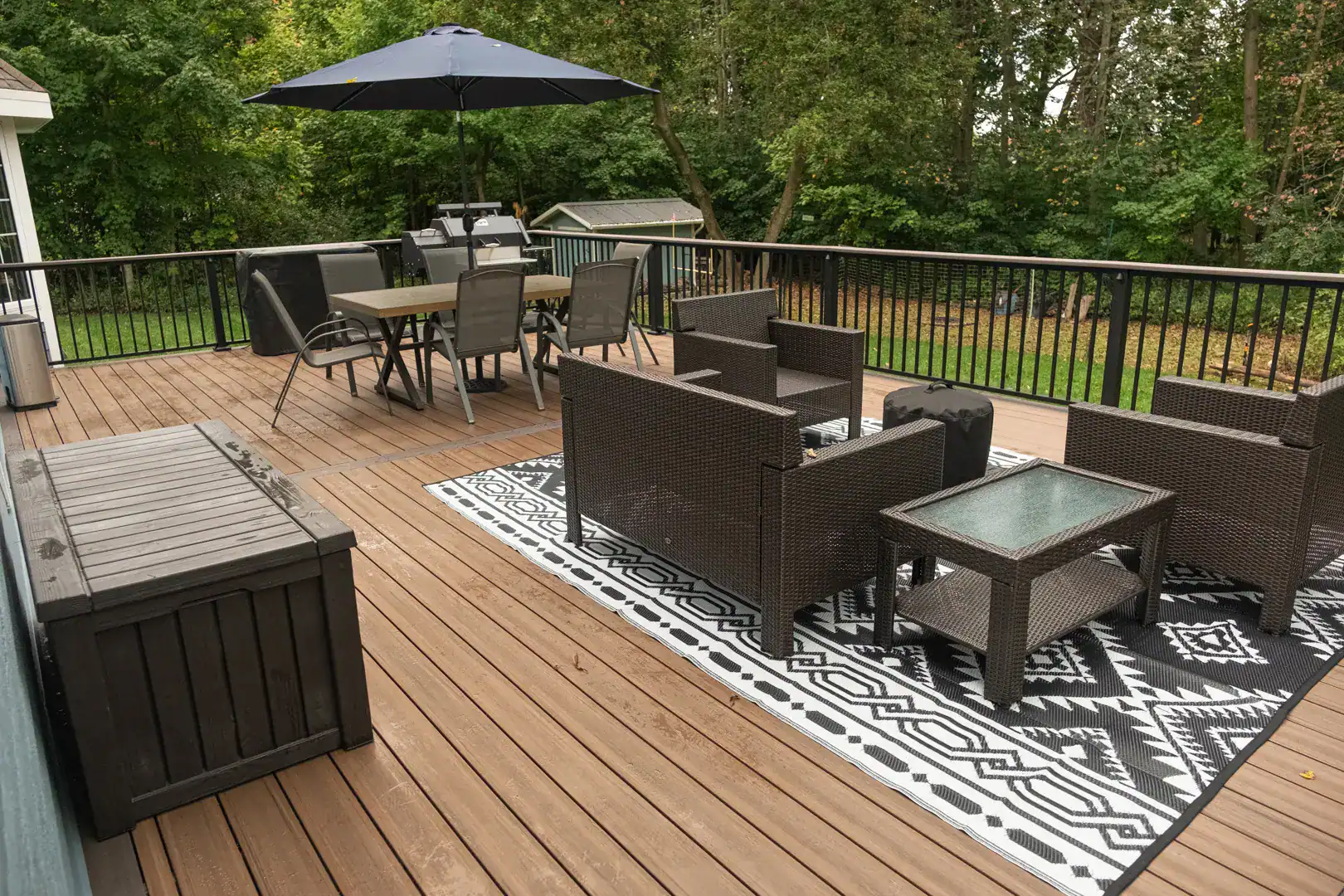 composite deck with black metal railing featuring outdoor furniture