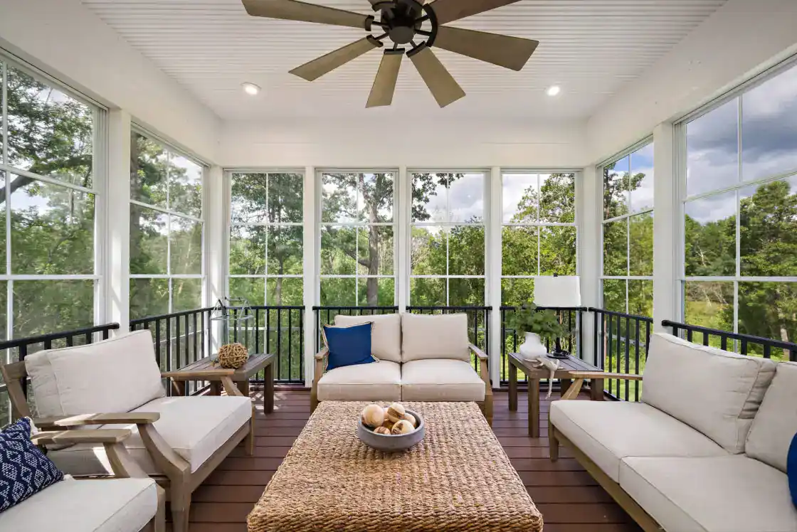 Custom screen porch with black railing featuring trees on the background in slinger wi