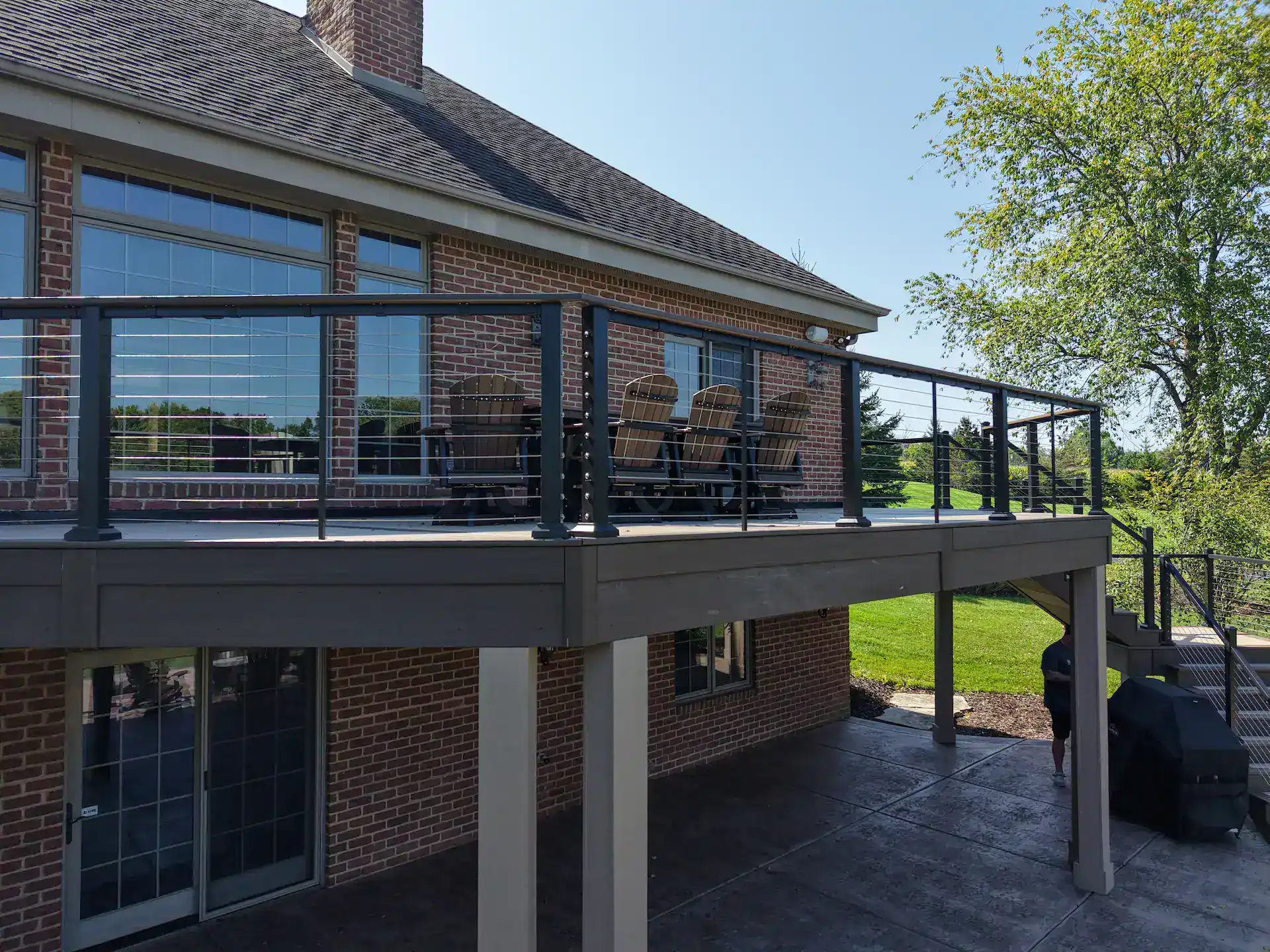 Elevated commercial deck with cable railing and outdoor living furniture in slinger wi