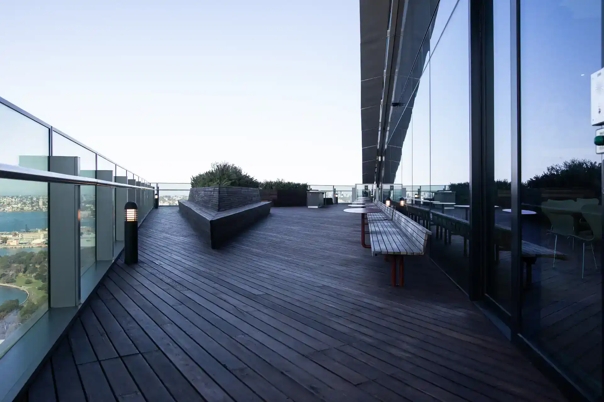 Perspective view of the commercial deck with glass railing and outdoor living space