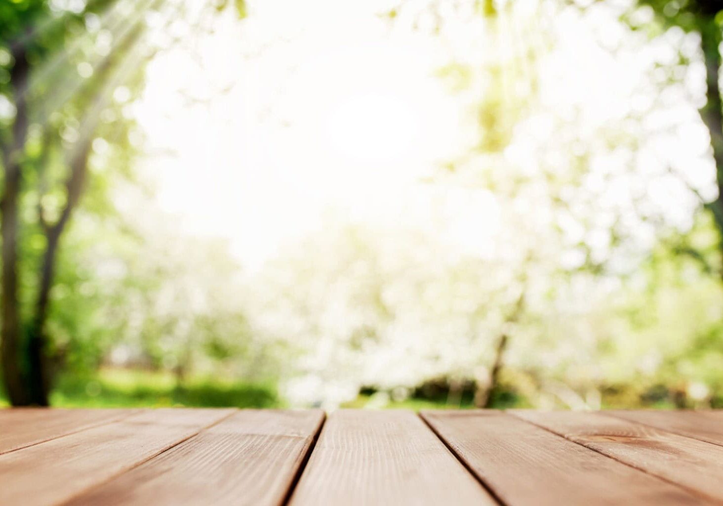sun rays on blurred view from wooden deck on balcony