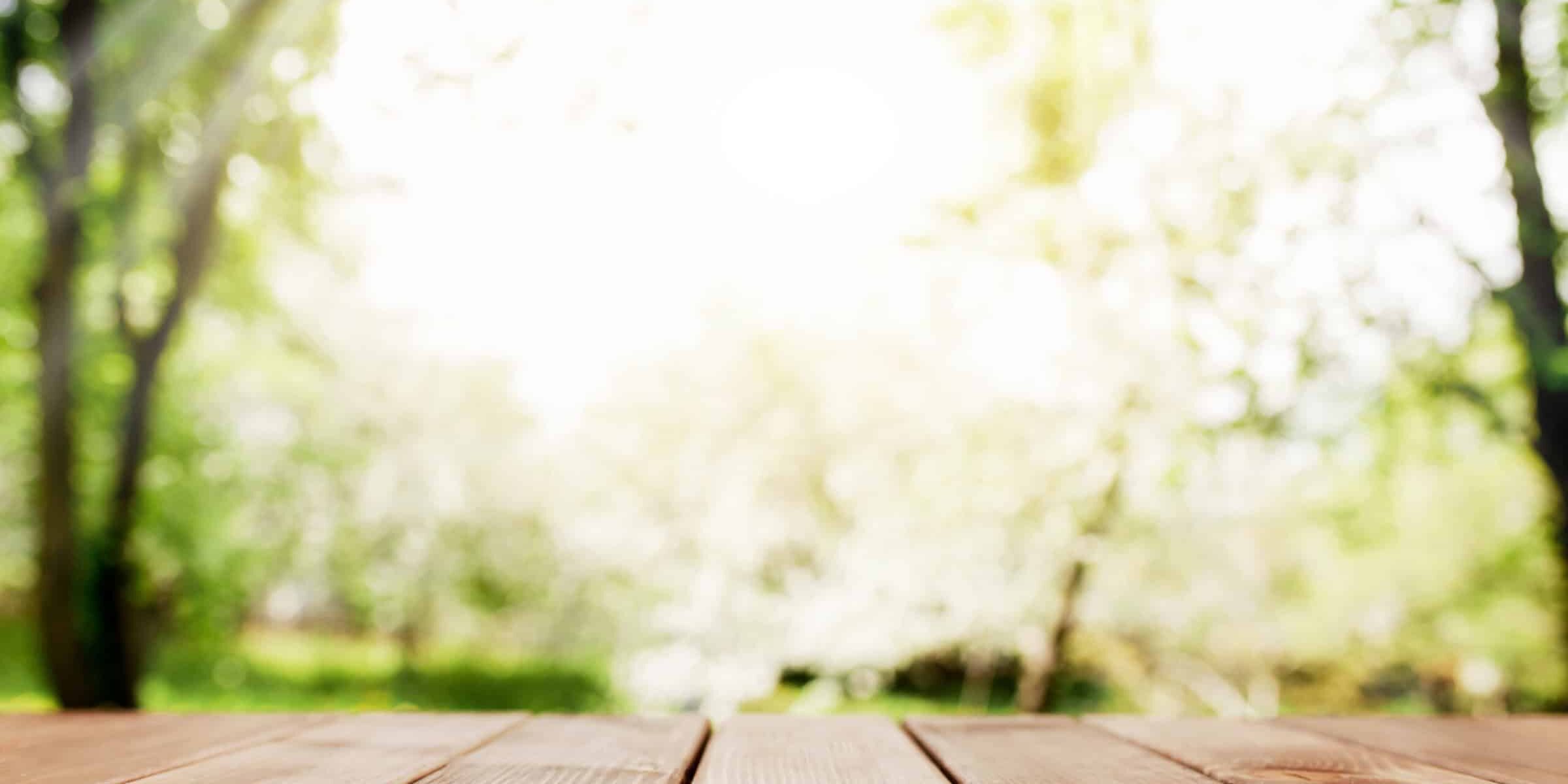 sun rays on blurred view from wooden deck on balcony
