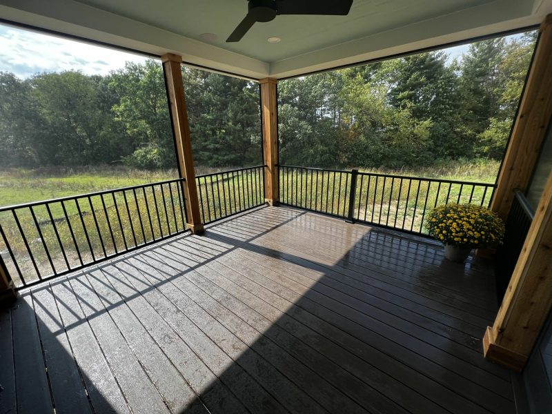 covered porch that is screened-in and has a ceiling fan for comfort.